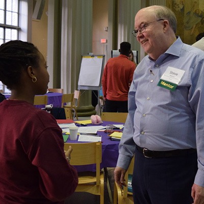 UPOP mentor talking with a student at TTW event